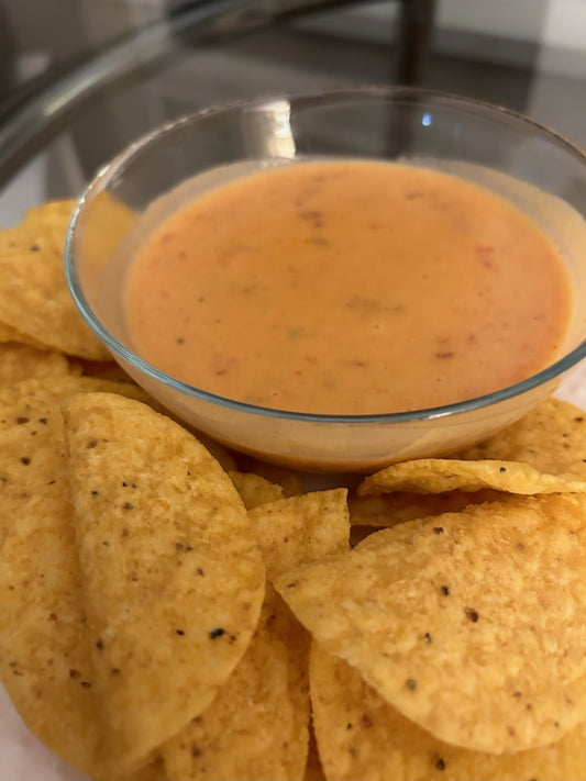 Cheese sauce in a dish with tortilla chips