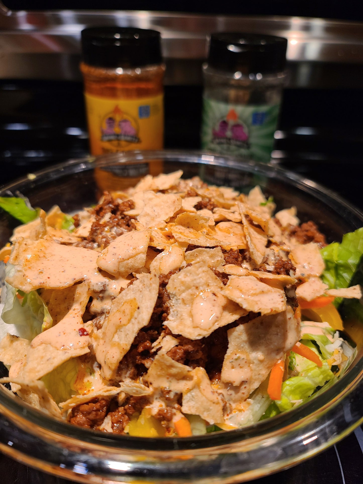 Salad topped with tortilla chips and smoke n sanity fajita ranch dressing