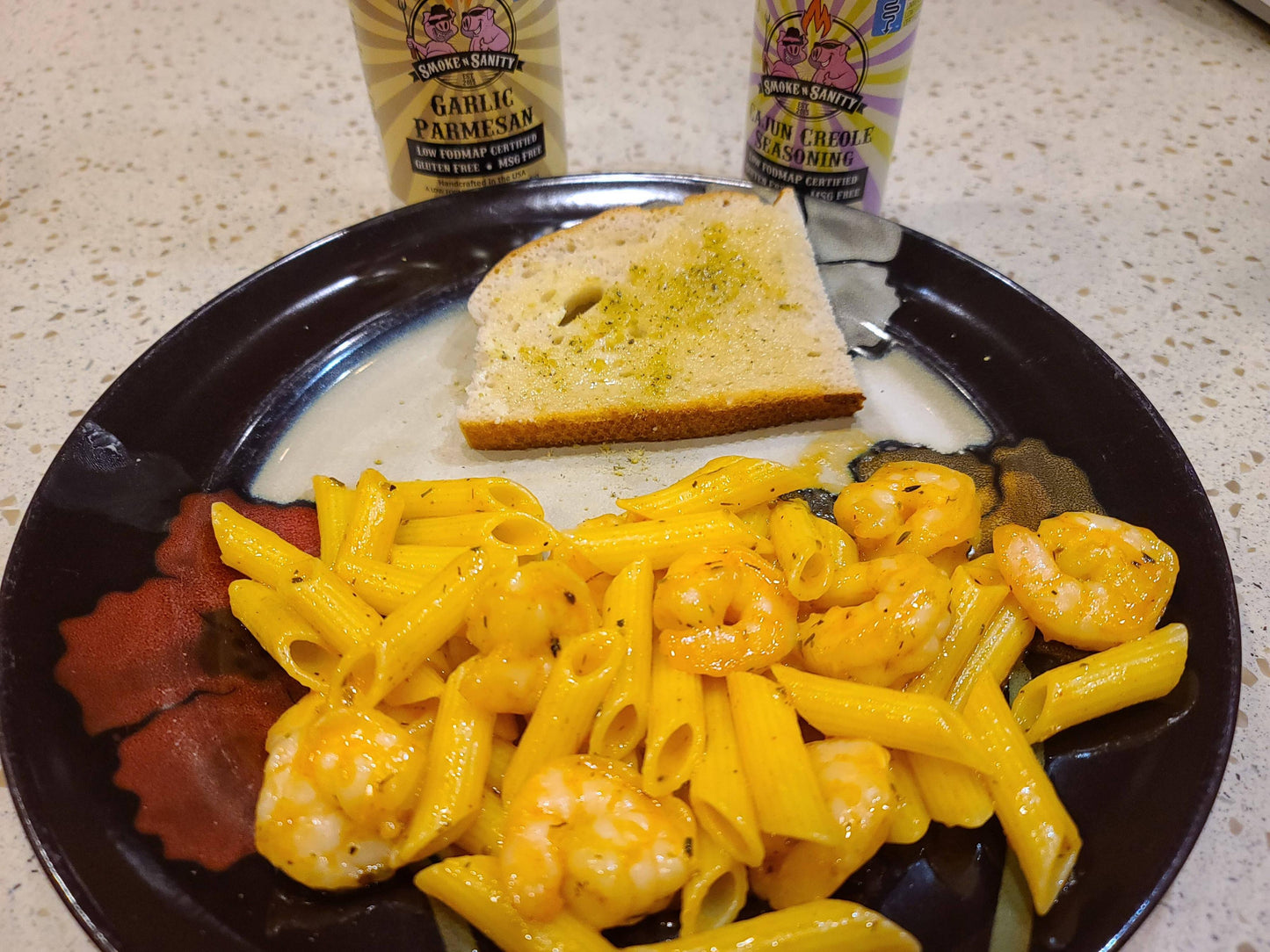 Plate of cajun creole shrimp pasta with a slice of garlic parmesan toast