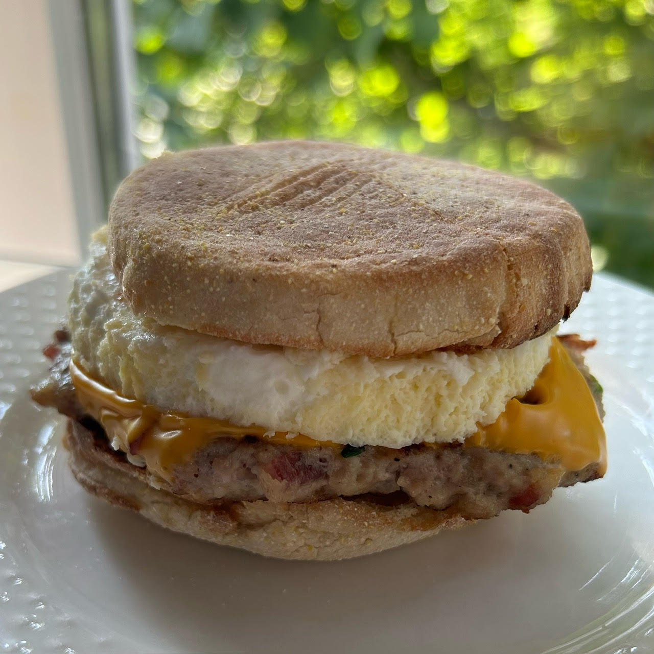 English muffin with egg, cheese, and sausage sandwich
