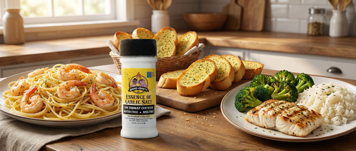 Essence of Garlic salt seasoning container on a kitchen counter with pasta, bread, and fish dishes.